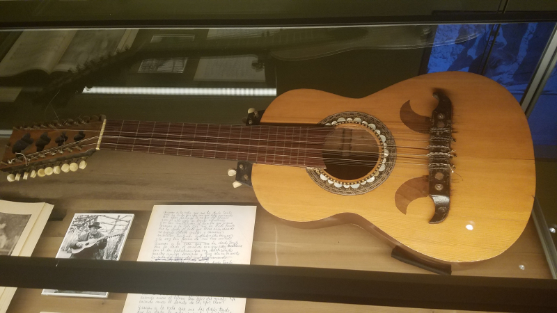 guitar and lyrics in glass case