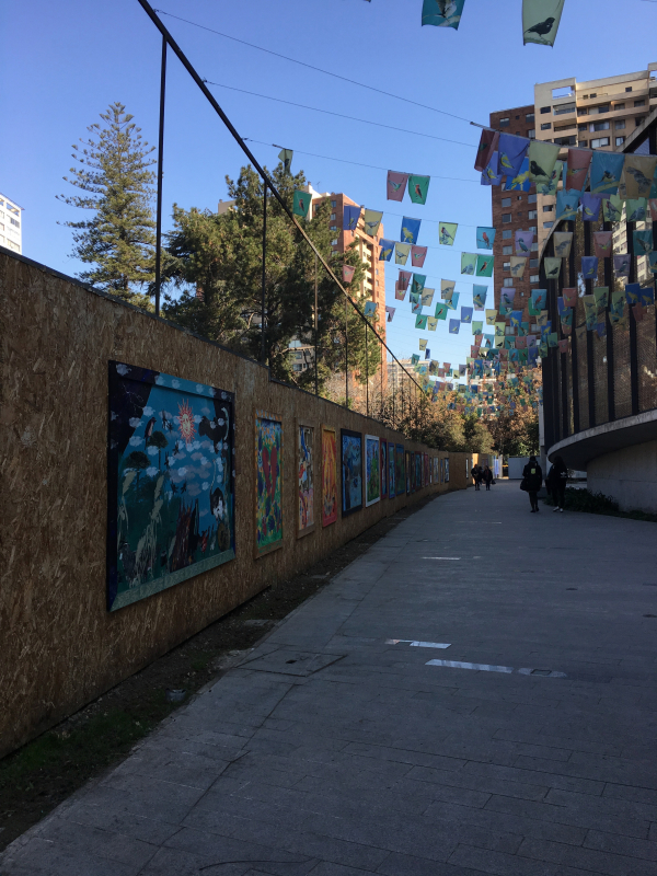 murals and hanging signs along pathway to museum