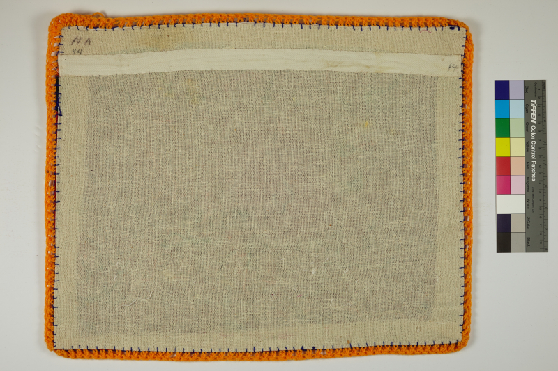 The back of an Arpillera lined with orange yarn